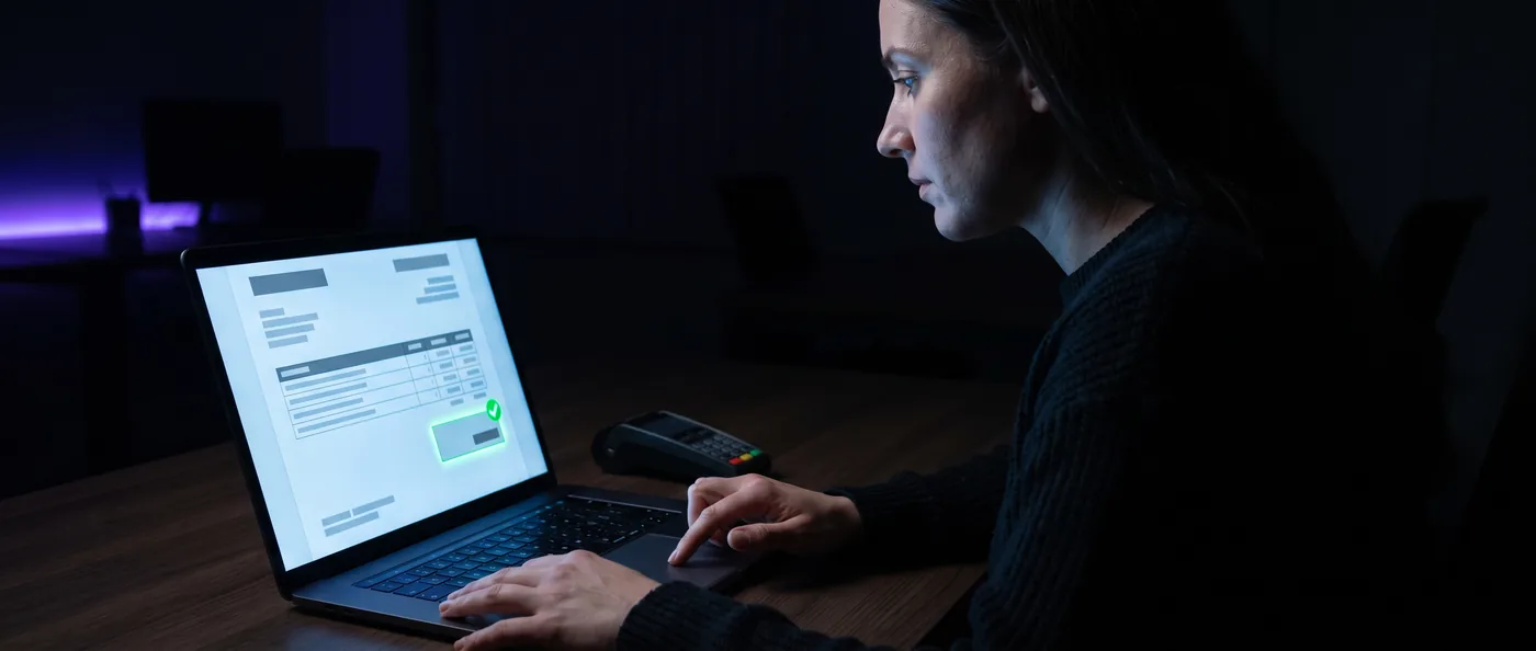 An administrator sending a digital invoice from a laptop, a confirmation tick on the screen.